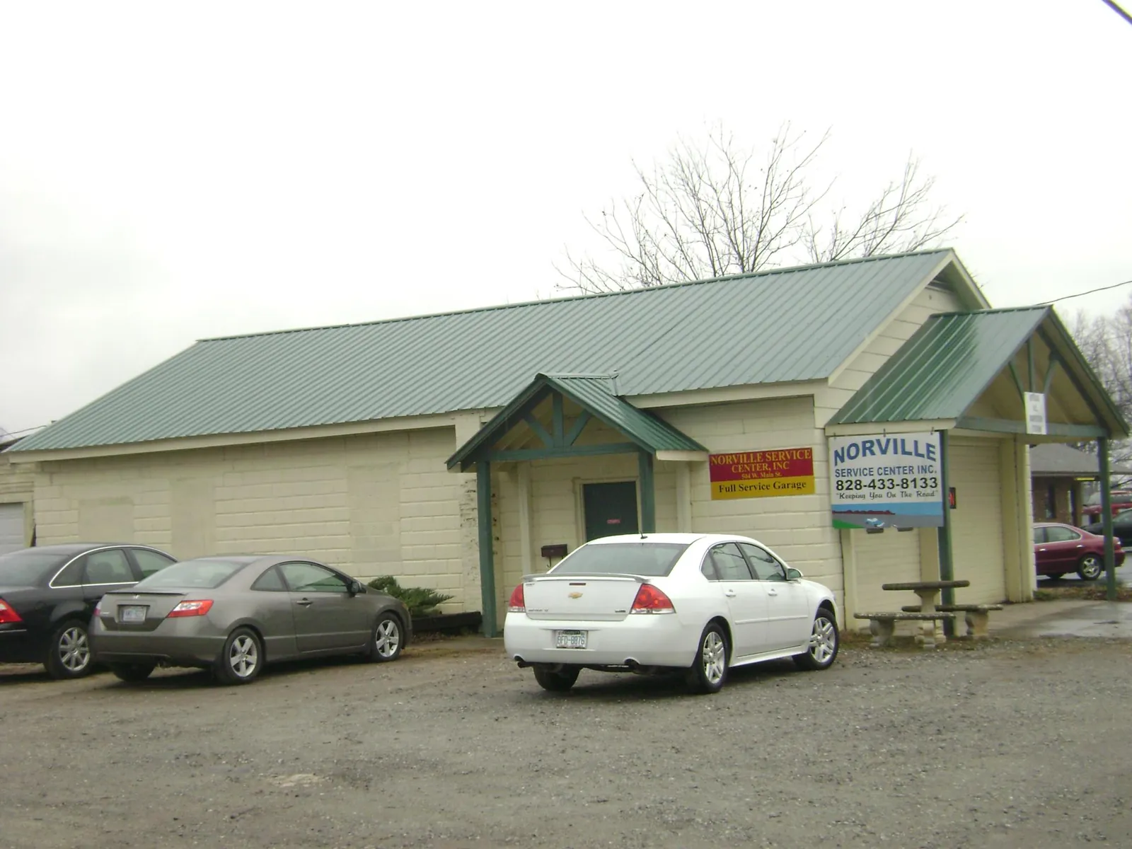 Green metal roof on a service garage with a covered entry in Hilltown